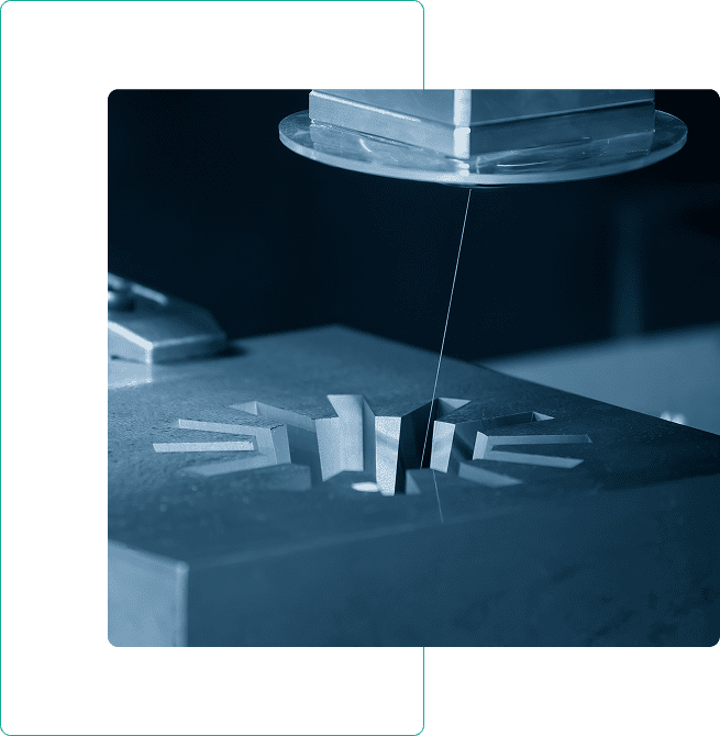 Wire EDM machine cutting metal shape.