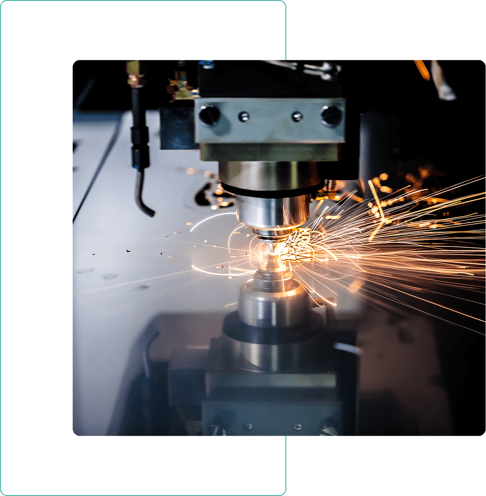 Machine cutting metal with flying sparks.
