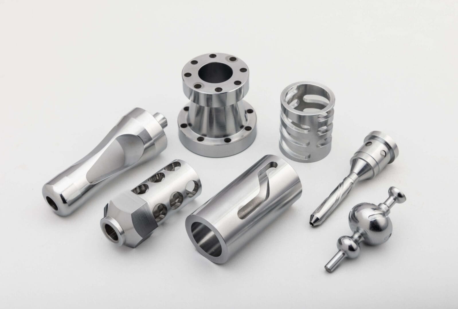 Metallic precision-engineered parts on white background.